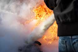 Parent extinguishing a fire in fire training